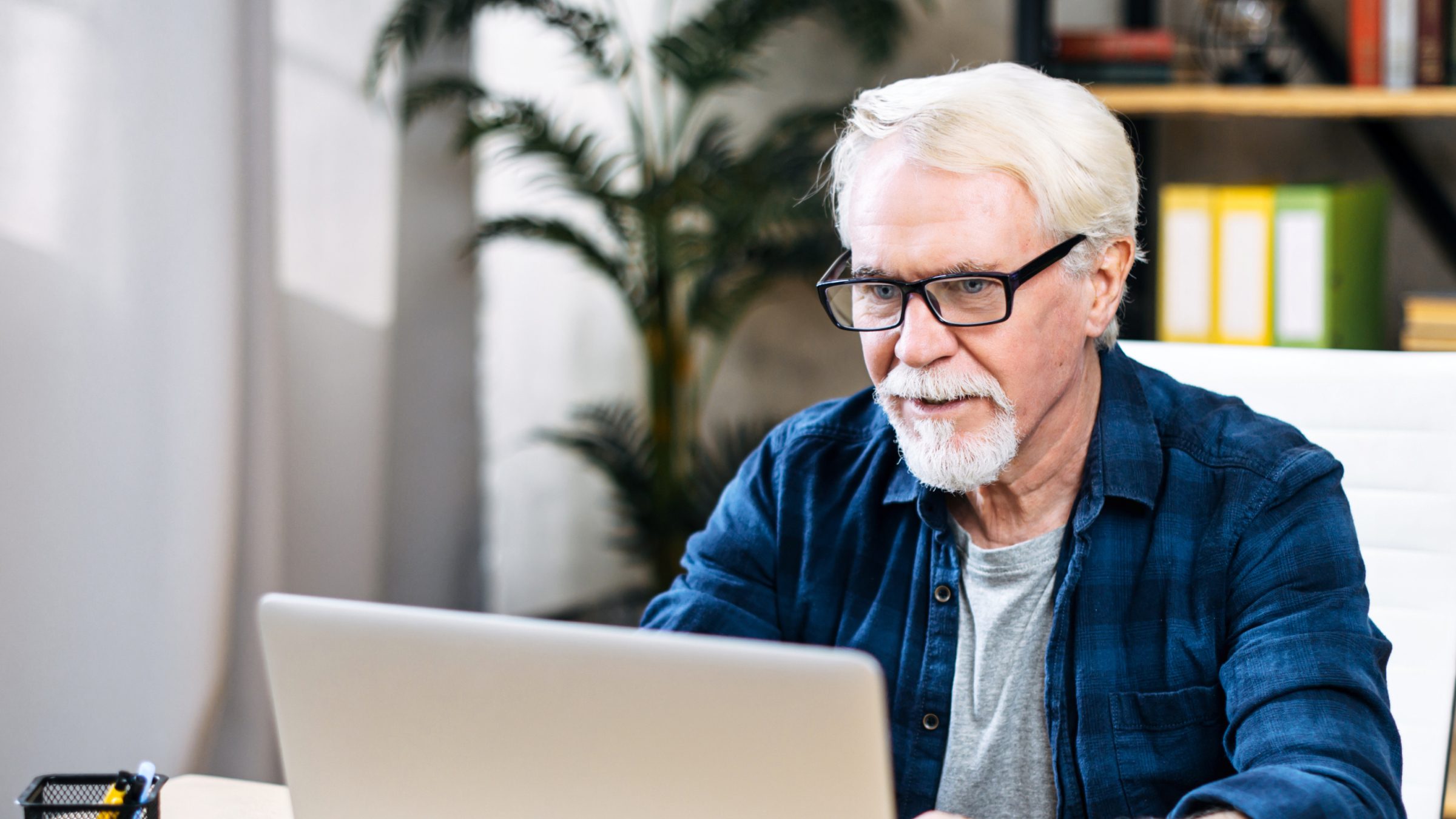An Eldera team member reading at a laptop