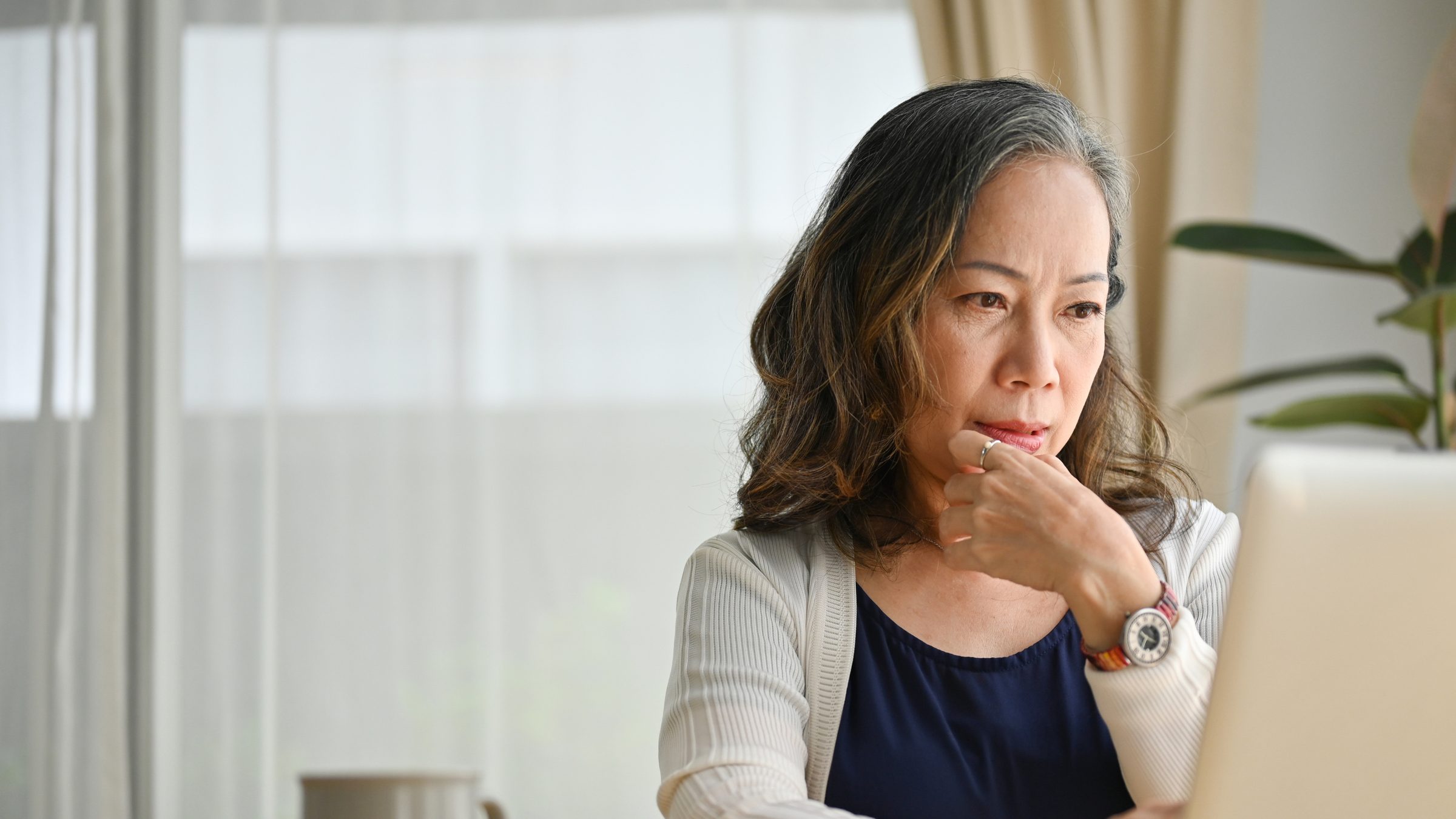 An Eldera mentor reading at her laptop