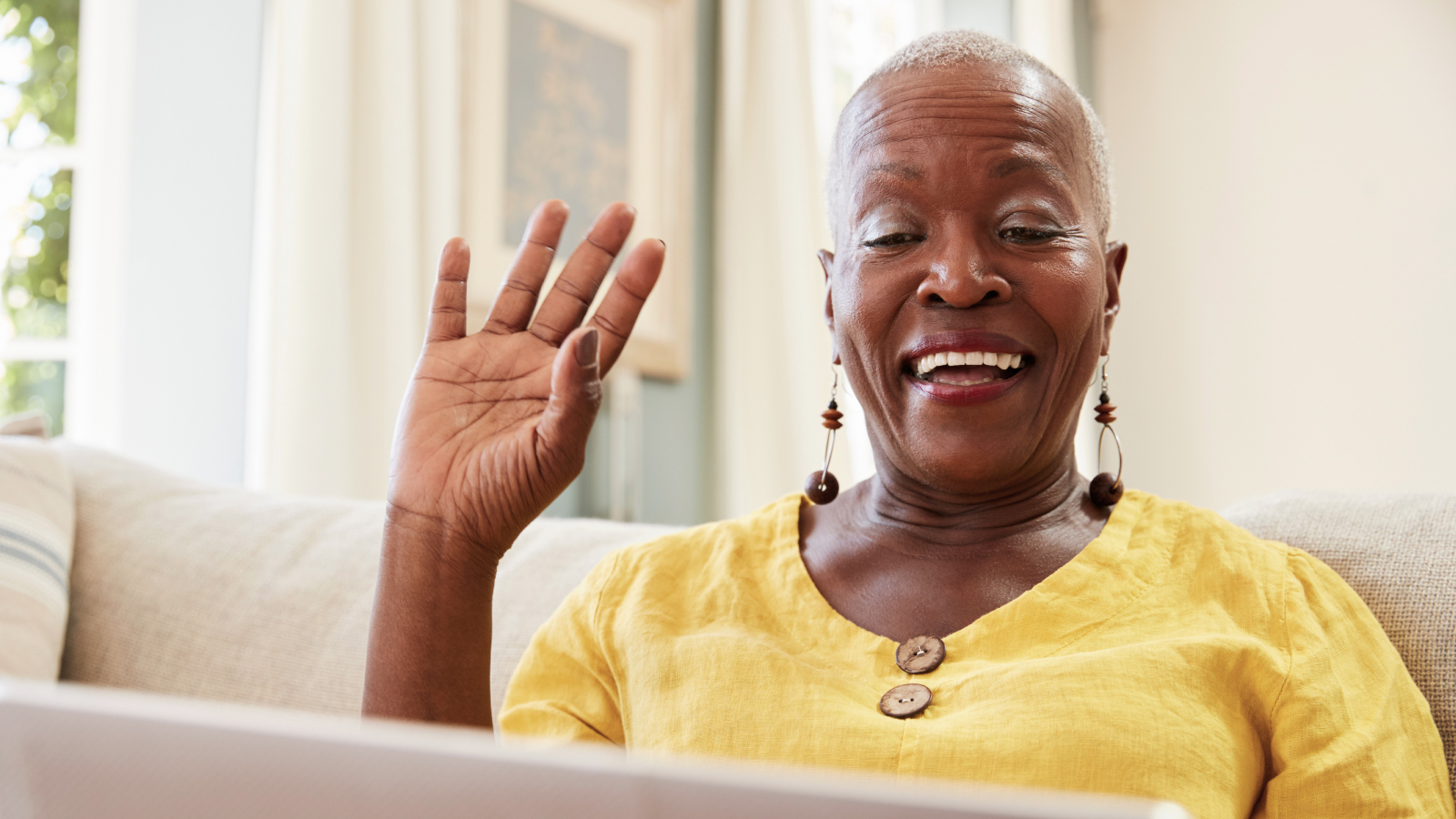 An older adult and a young person in conversation during a video call